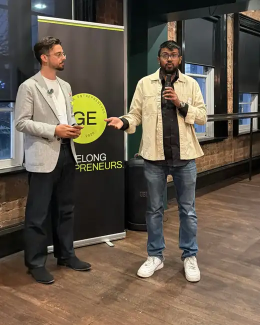 Two speakers at a Geelong Entrepreneurs night, standing beside the GE banner